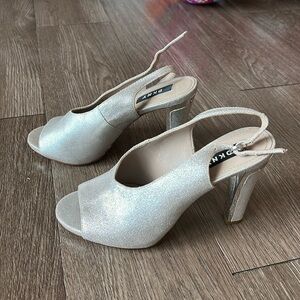 Brand new DKNY silver heels.